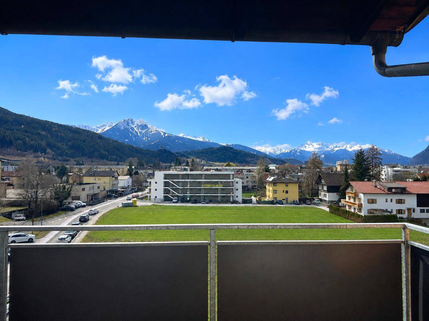 Balkon mit weitem Blick auf die schneebedeckten Berge und die umliegende Landschaft.
