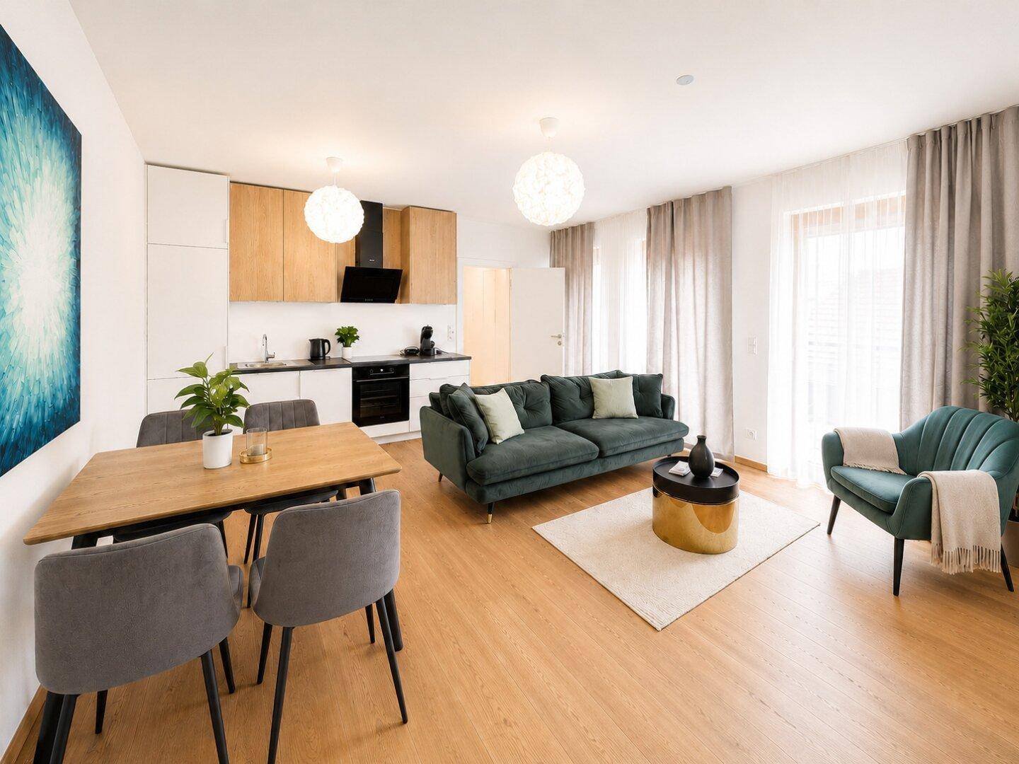 Offener Wohn-Essbereich mit integrierter Küche, Holzfußboden und modernen Möbeln.