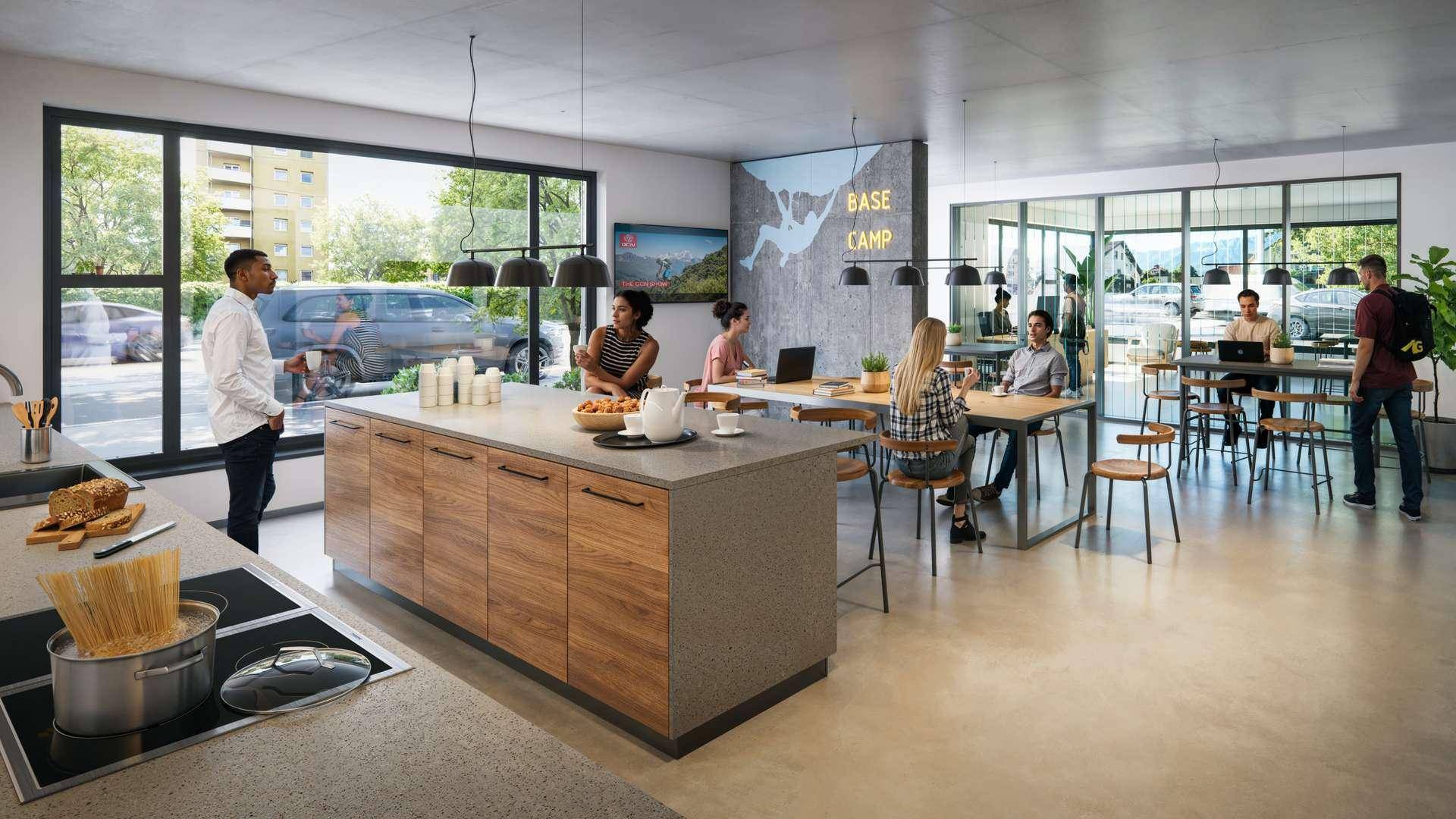 Großer offener Gemeinschaftsbereich mit moderner Küche, Esstischen und Arbeitsplätzen.