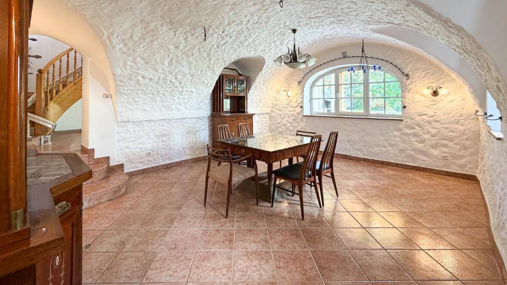 Rustikaler Essbereich mit Gewölbedecke, Terrakottafliesen und Holzmöbeln.