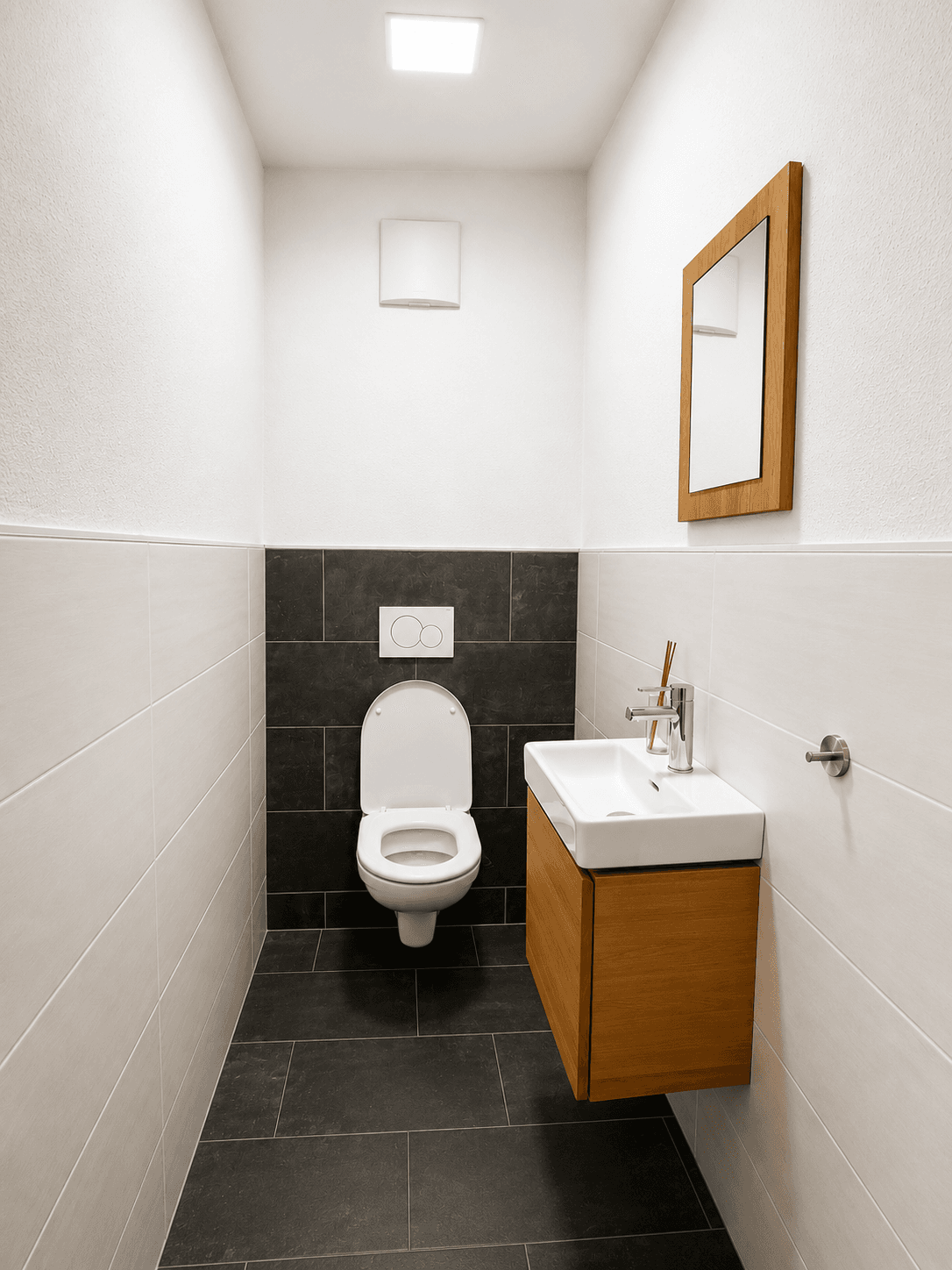 Separates Gäste-WC mit wandhängender Toilette, kleinem Waschbecken und modernen Fliesen.