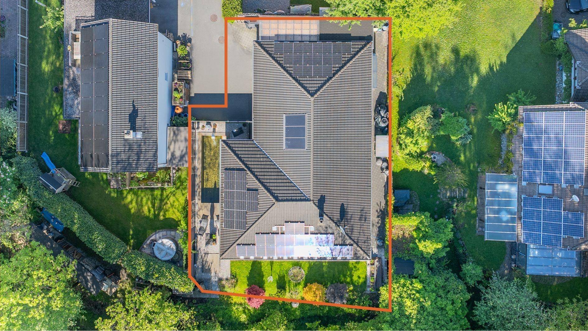 Vogelperspektive des Anwesens mit Haus, Garten, Solaranlagen und Grundstücksgrenzen.