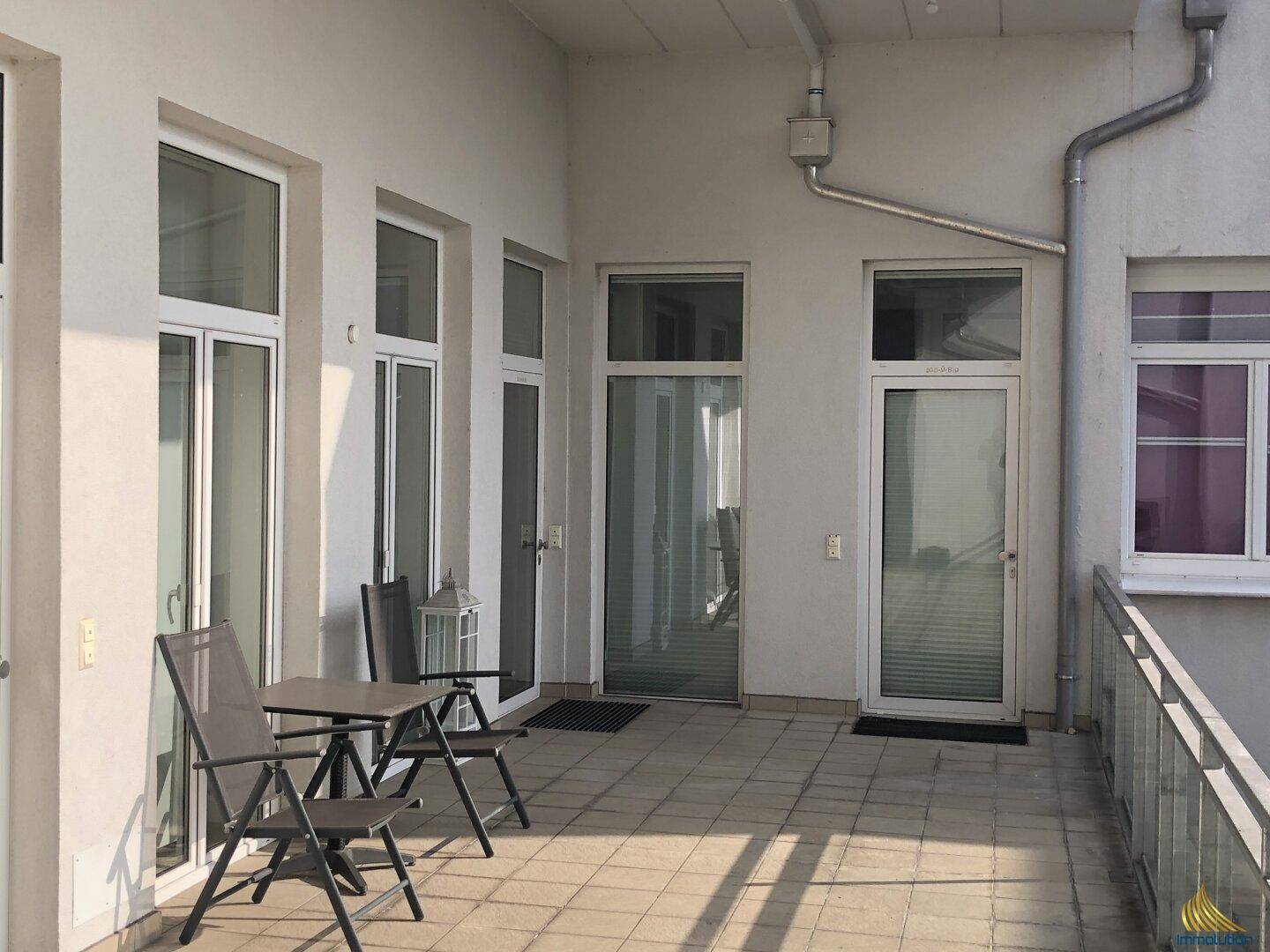 Geräumige Terrasse mit Sitzgelegenheiten und direktem Zugang zu den Innenräumen.