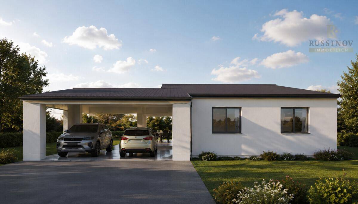 Ansicht eines modernen Einfamilienhauses mit großem Carport für zwei Fahrzeuge und gepflegtem Vorgarten.