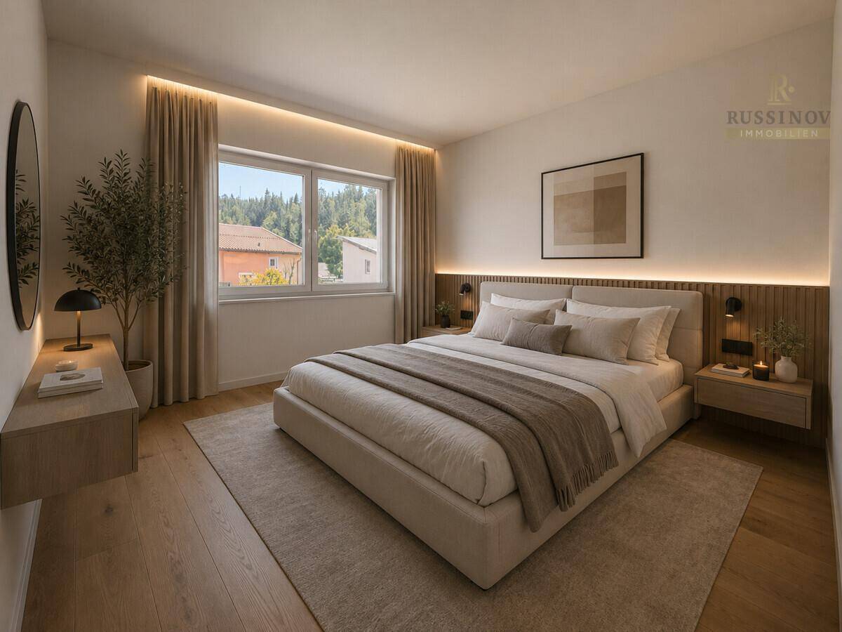Helles Schlafzimmer mit großem Bett, modernen Nachttischen und Blick ins Grüne.