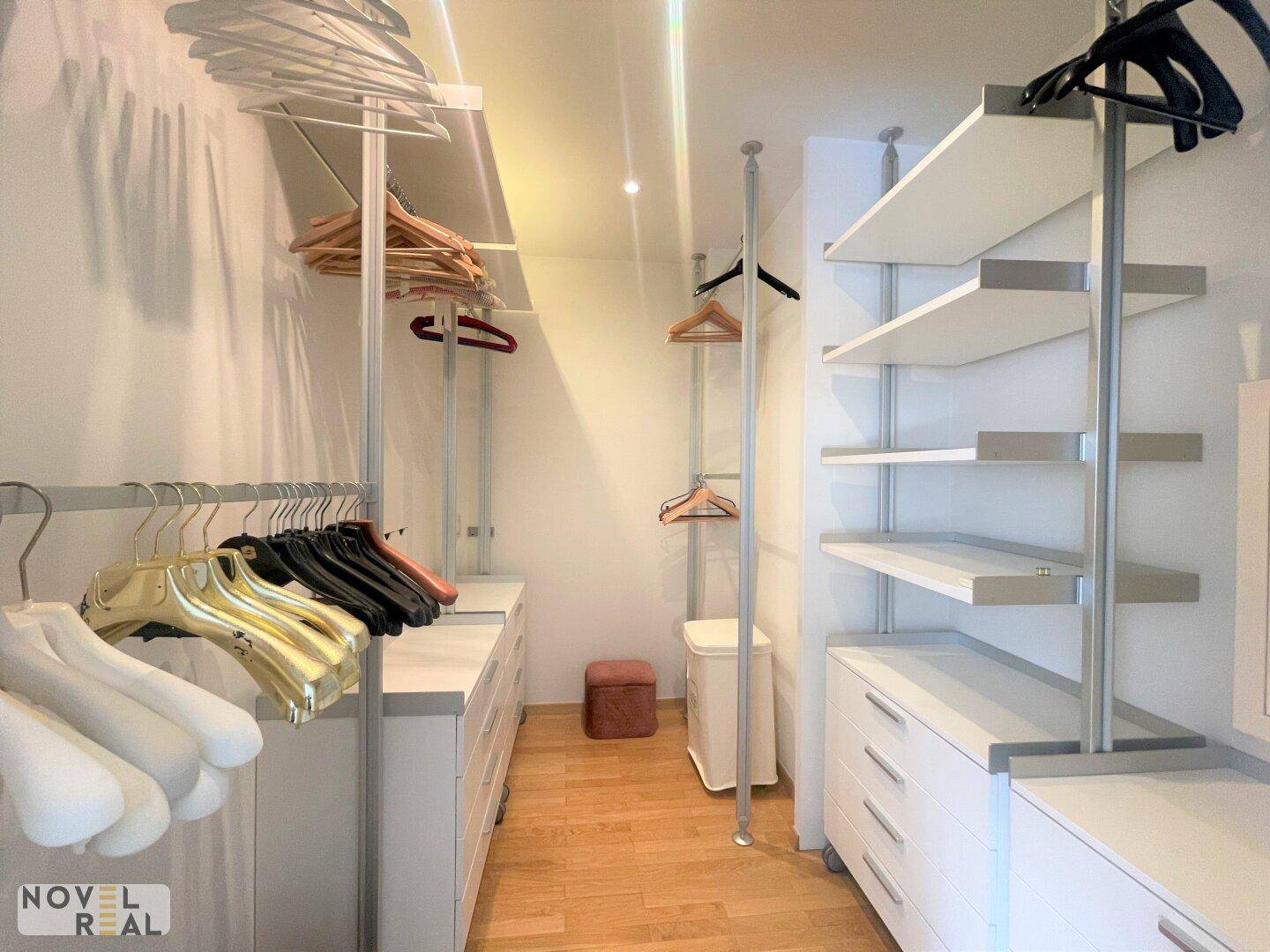 Praktischer begehbarer Kleiderschrank mit Regalen und Schubladen für optimale Organisation.