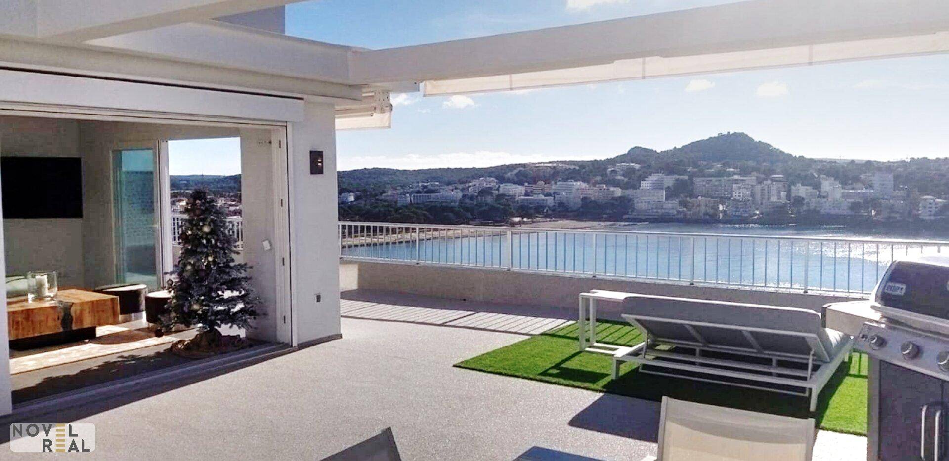 Sonnige Dachterrasse mit Grill und weitem Blick über das Meer und die Küstenlandschaft.