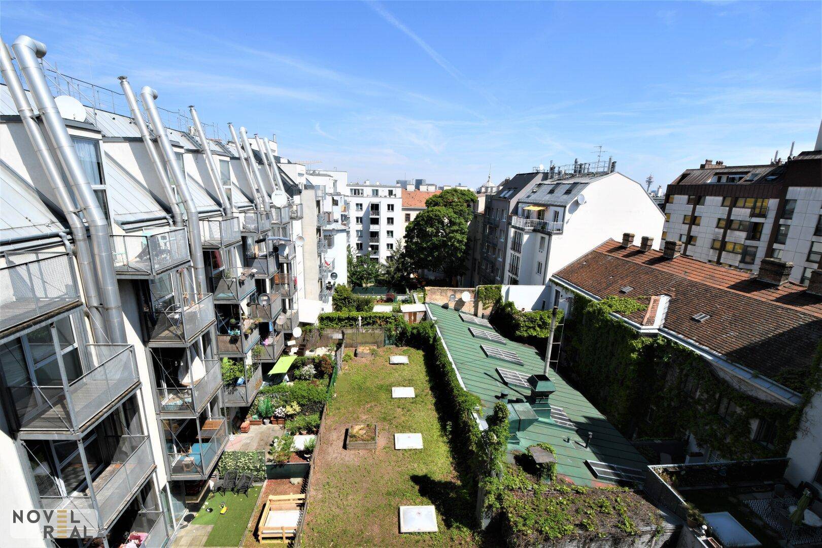 Panoramablick über Wohngebäude mit begrünten Dächern und Balkonen in der Stadt.