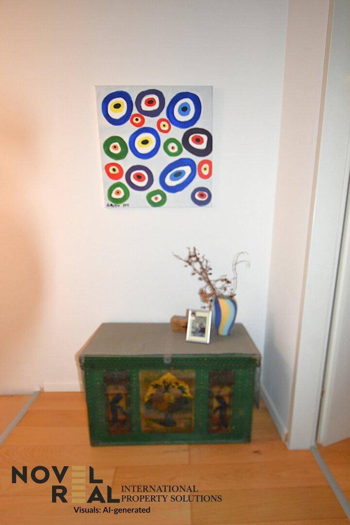 Dekorativer Flurbereich mit einer bemalten Truhe und einem farbenfrohen Kunstwerk an der Wand.