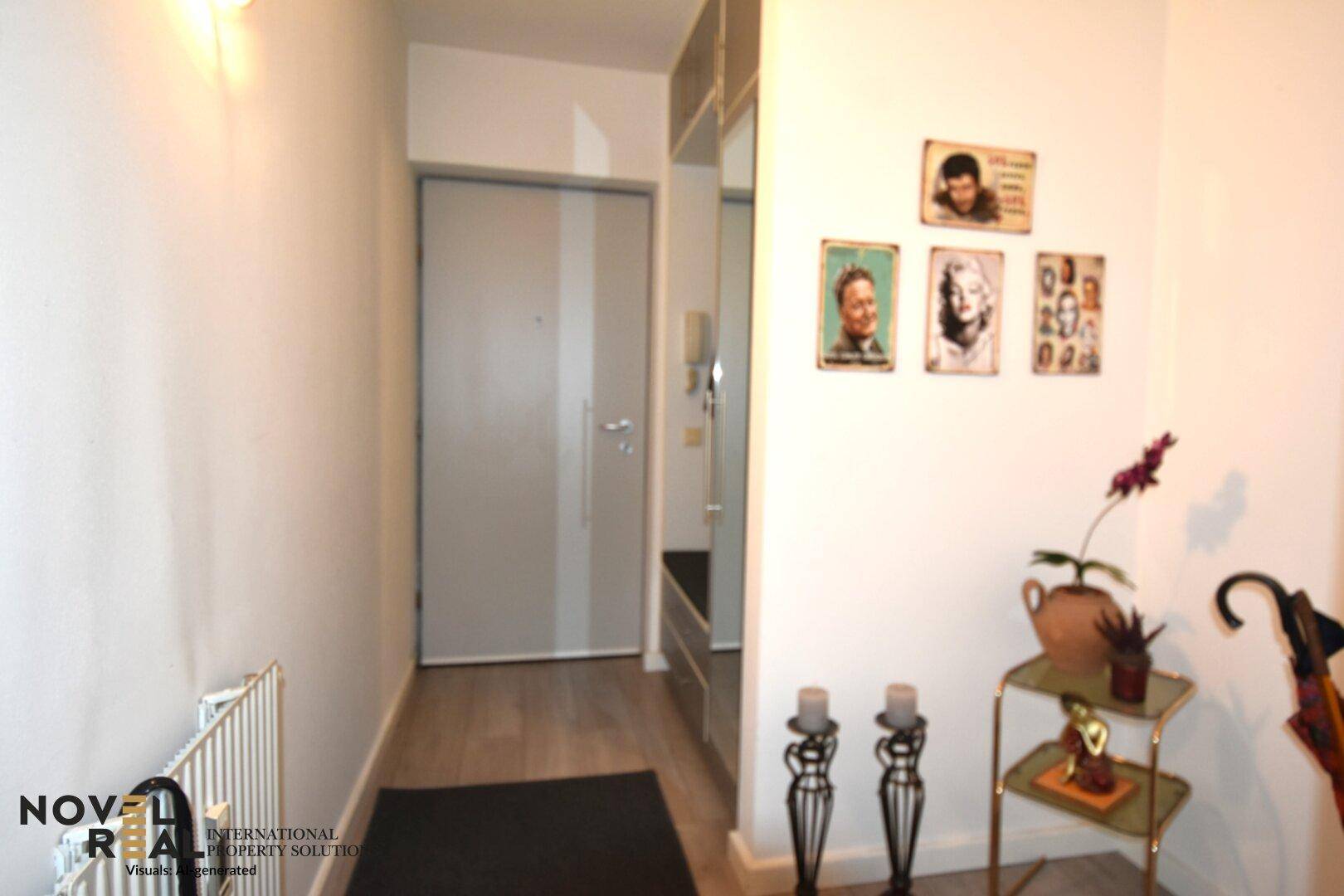 Eingangsbereich mit Garderobe, Spiegel und einer modernen Tür.