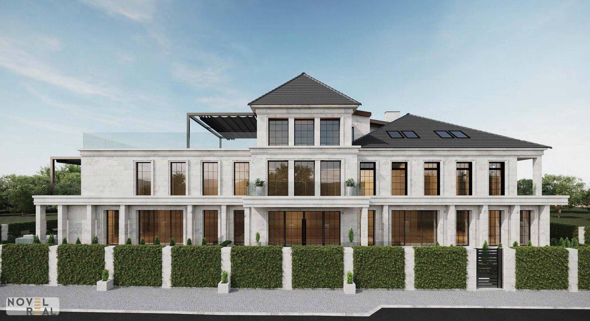 Repräsentative Fassade einer modernen Villa mit Flachdach und gepflegter Hecke.