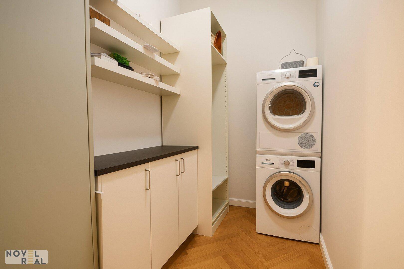 Praktischer Hauswirtschaftsraum mit Waschmaschine, Trockner und Regalsystem.