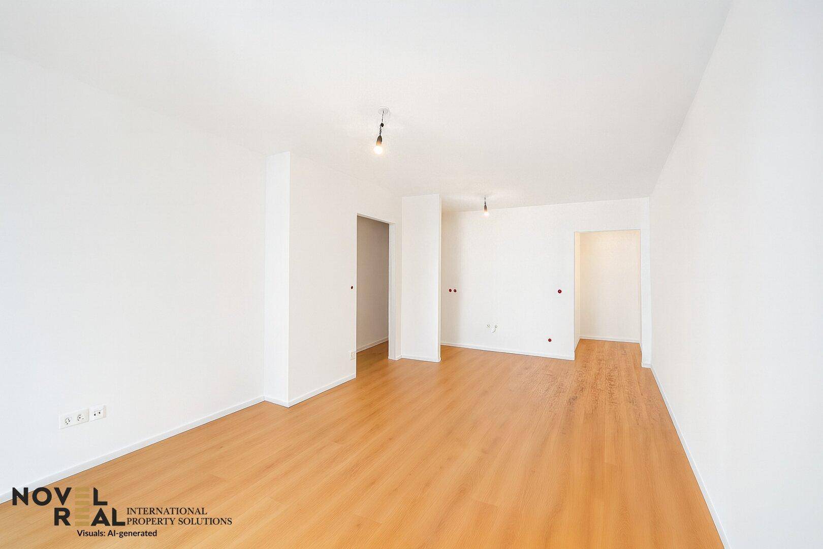 Geräumiges, leeres Zimmer mit hellem Holzboden und weißen Wänden.