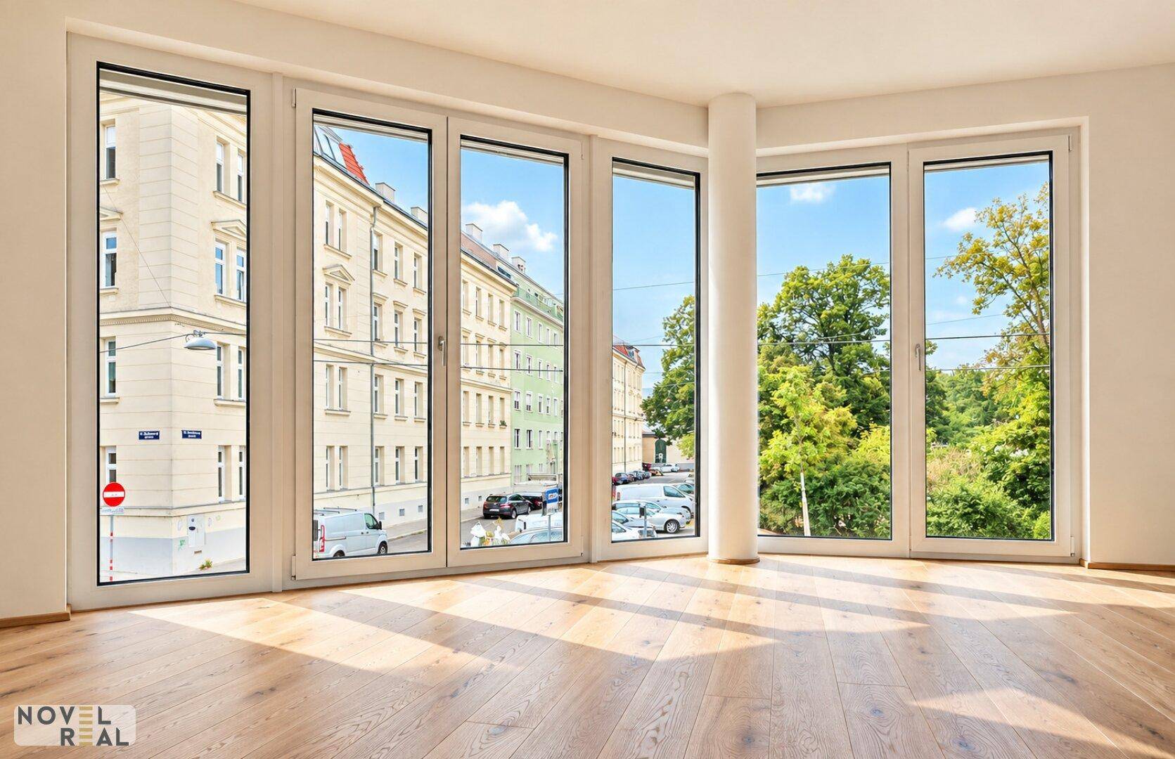 Lichtdurchfluteter Wohnbereich mit Eichenparkett und weitem Blick auf die Stadt und grüne Bäume.