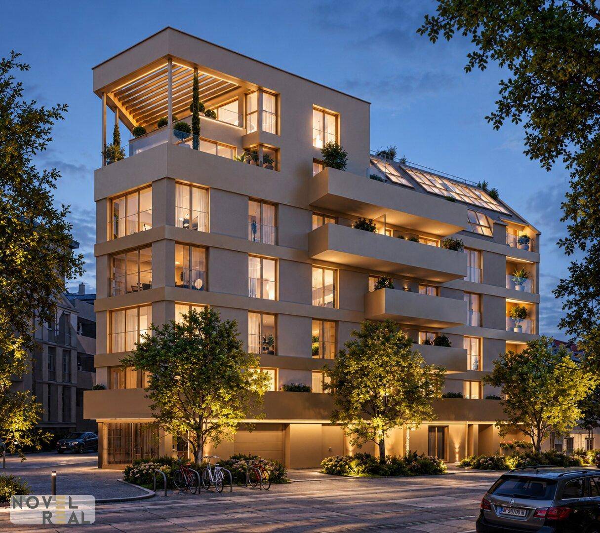 Modernes Apartmentgebäude bei Nacht mit beleuchteten Innenräumen und Balkonen.