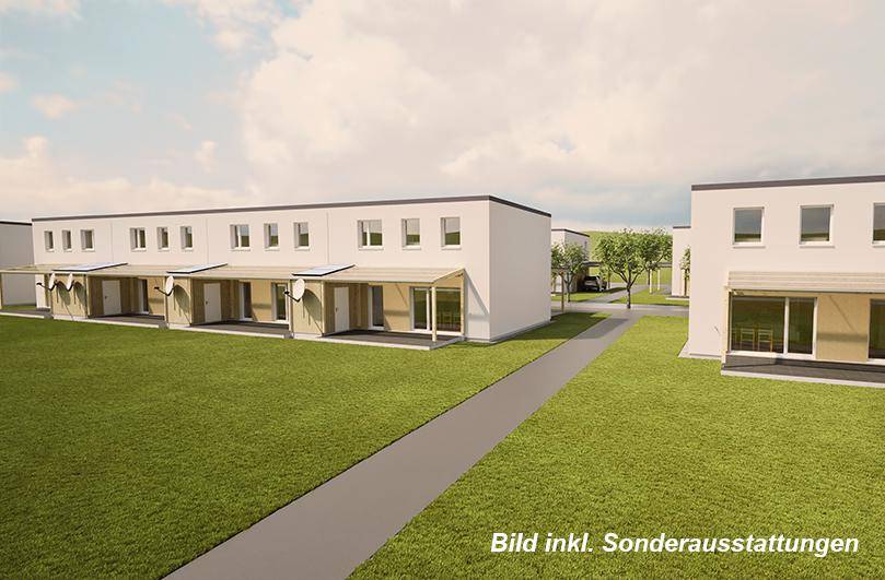 Übersicht über eine Siedlung mit modernen Reihenhäusern und weitläufigen Grünflächen.