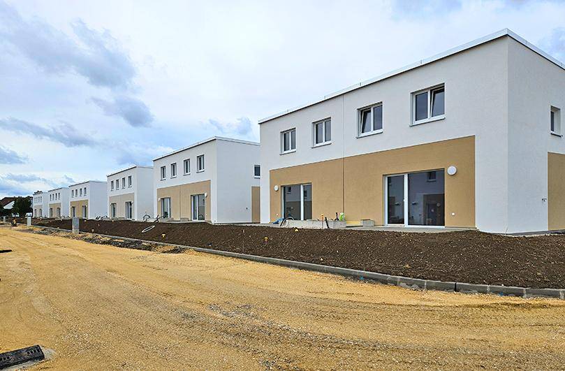 Reihenhäuser im Neubaugebiet mit moderner Architektur und noch unfertiger Außenanlage.
