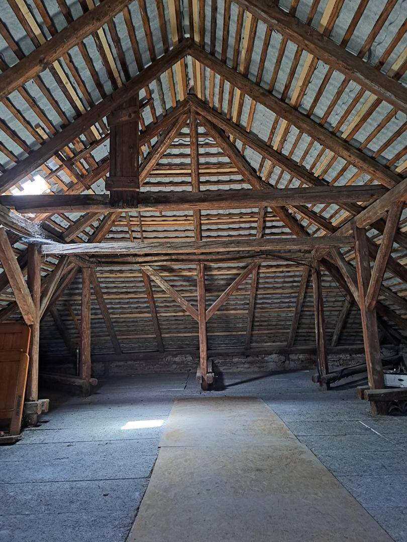 Geräumiger Dachboden mit sichtbarer Holzkonstruktion und Dachschrägen.