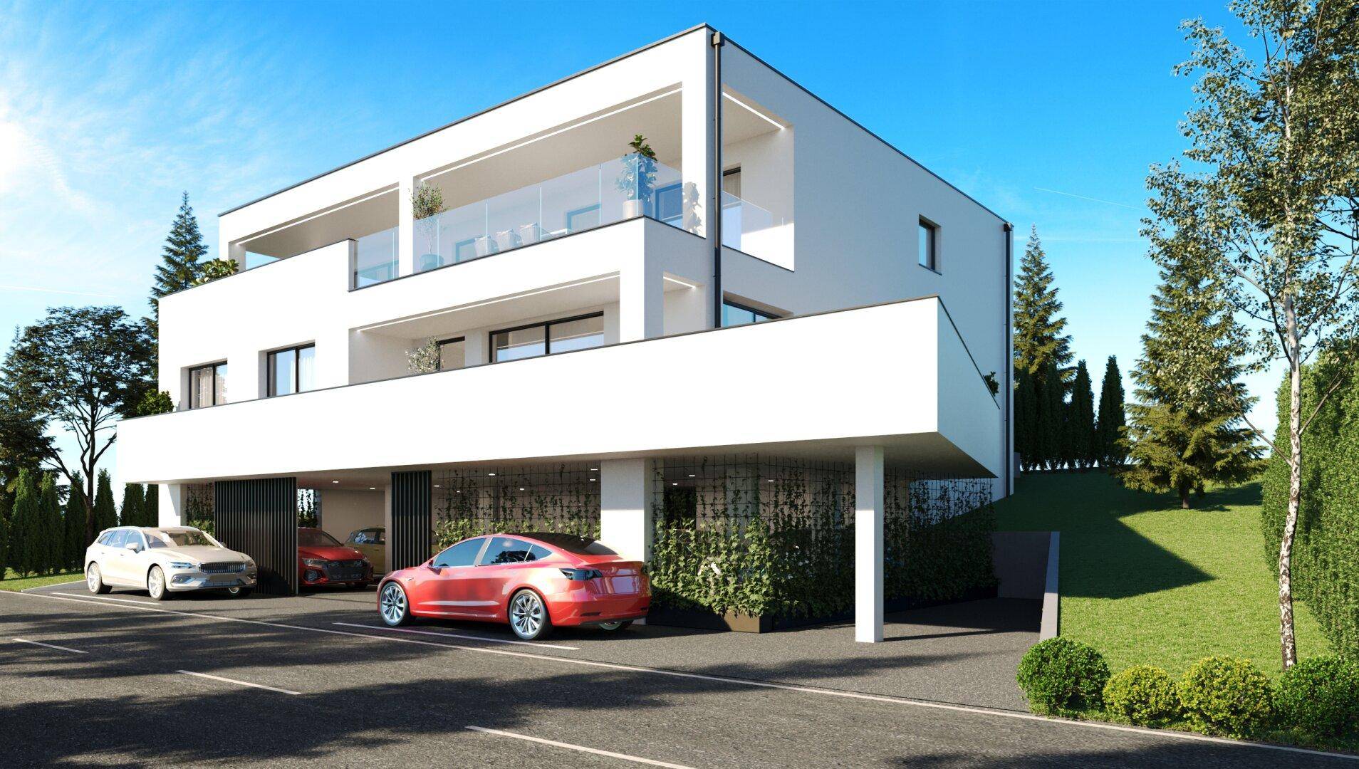 Modernes Mehrfamilienhaus mit weißer Fassade, Balkonen und Tiefgaragenzufahrt.