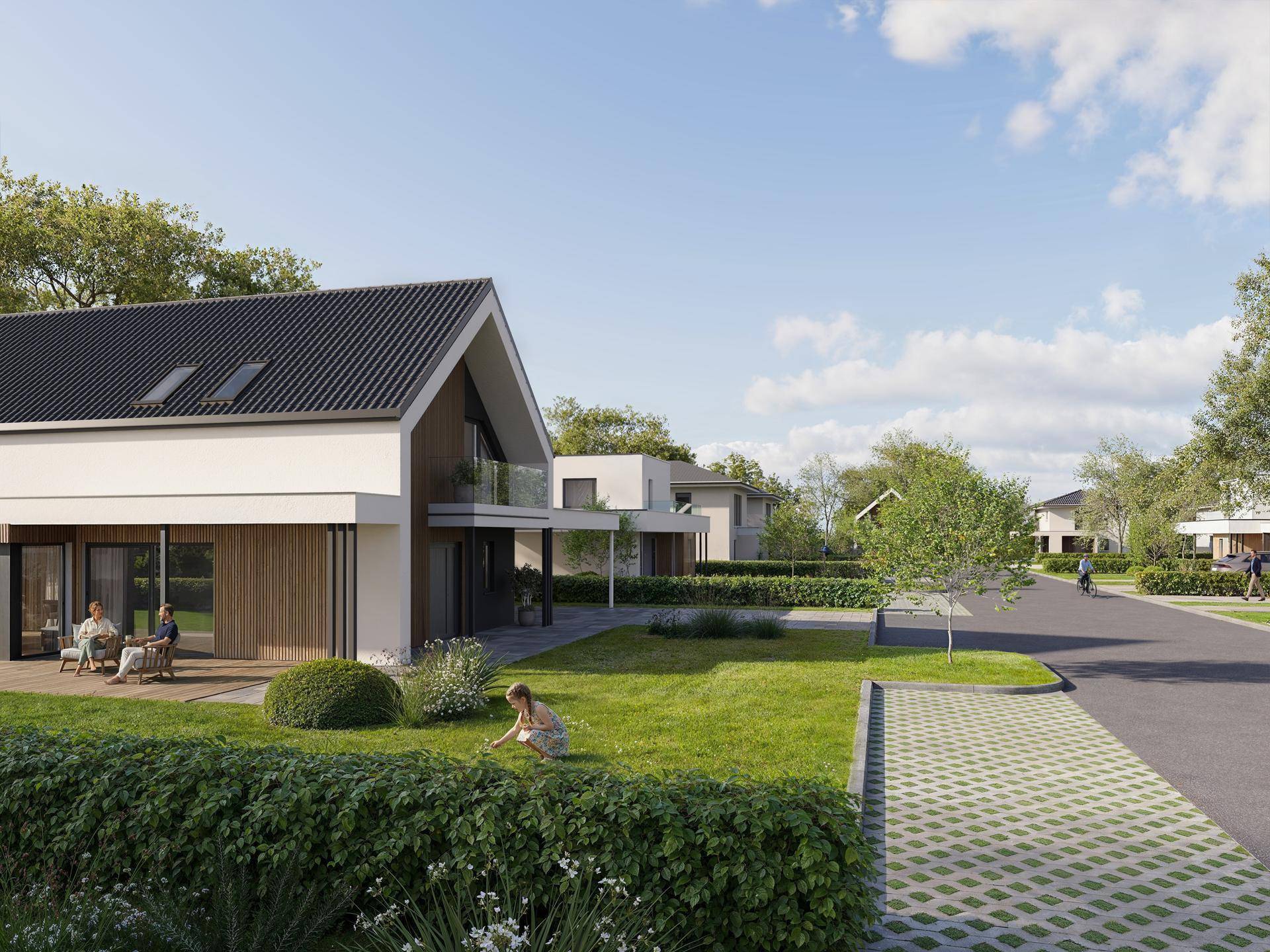Moderne Hausfassade mit Terrasse, Garten und Blick auf die ruhige Wohnstraße der Siedlung.