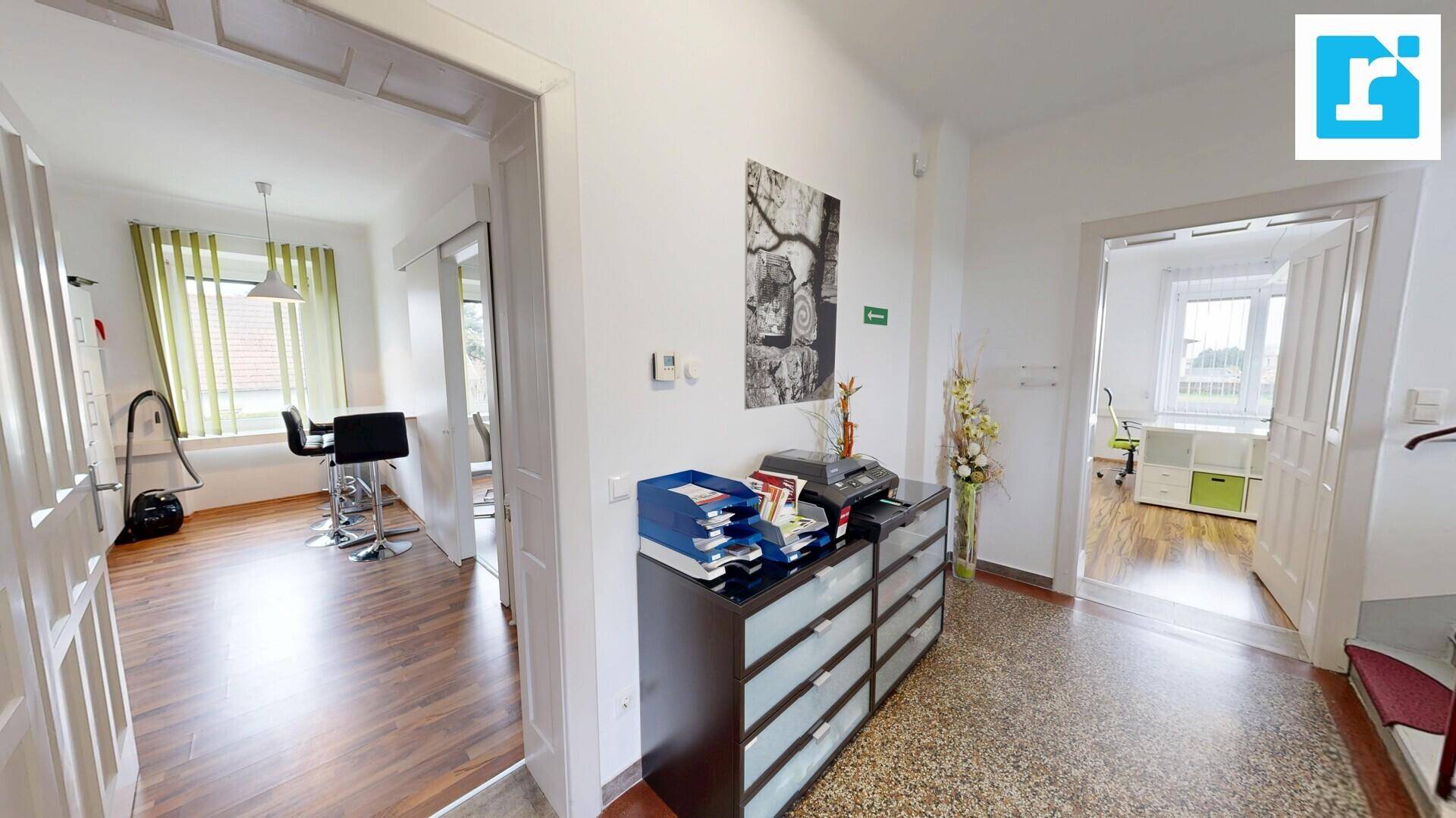 Flur mit Terrazzoboden, einem Aktenschrank und Zugang zu mehreren Büroräumen, funktional und hell.
