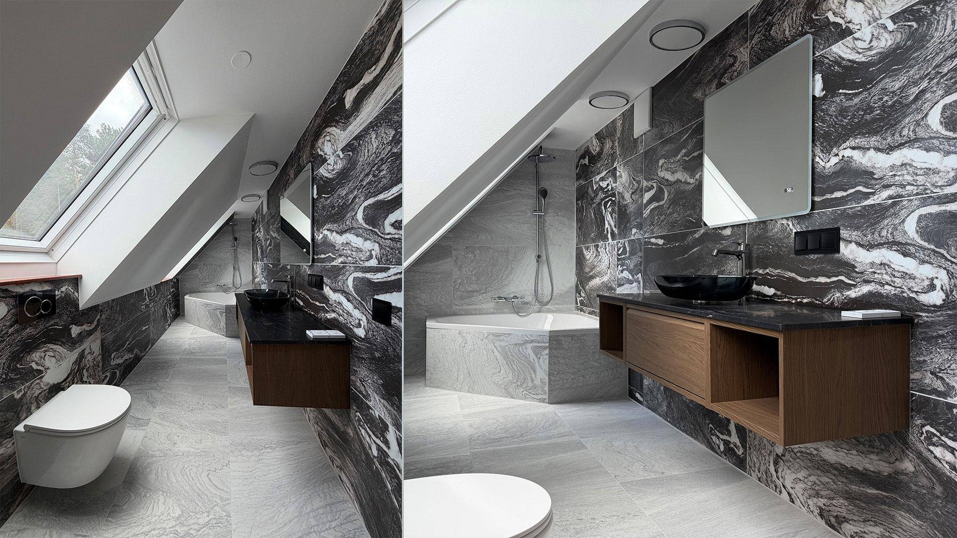 Modernes Dachgeschossbad mit Marmorfliesen, Badewanne, Waschtisch und Dachfenster.