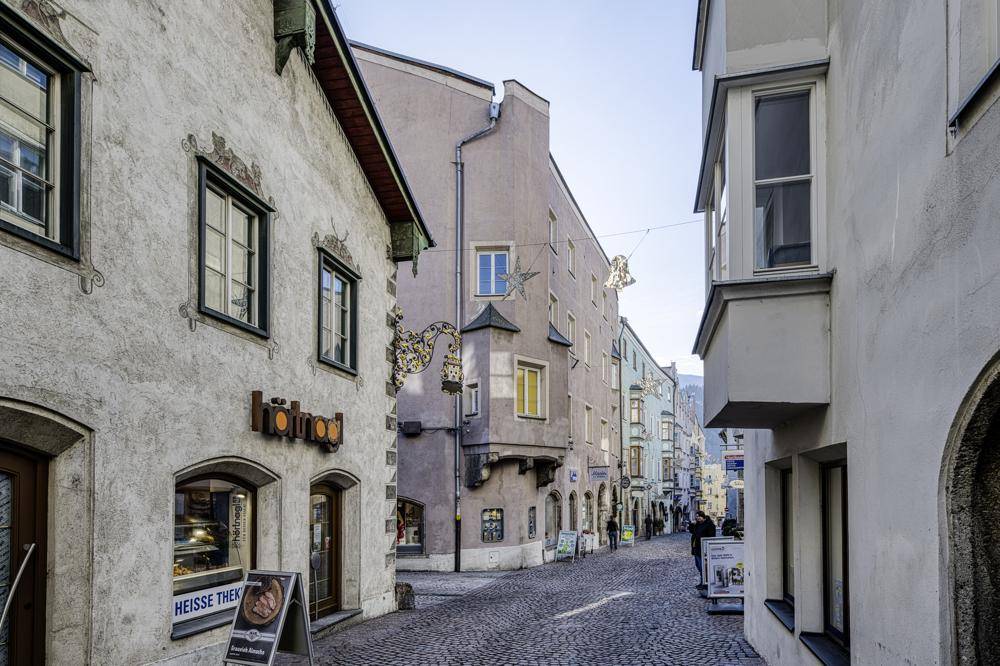 Historische Gasse mit charmanten Gebäuden, Kopfsteinpflaster und traditionellen Schaufenstern.