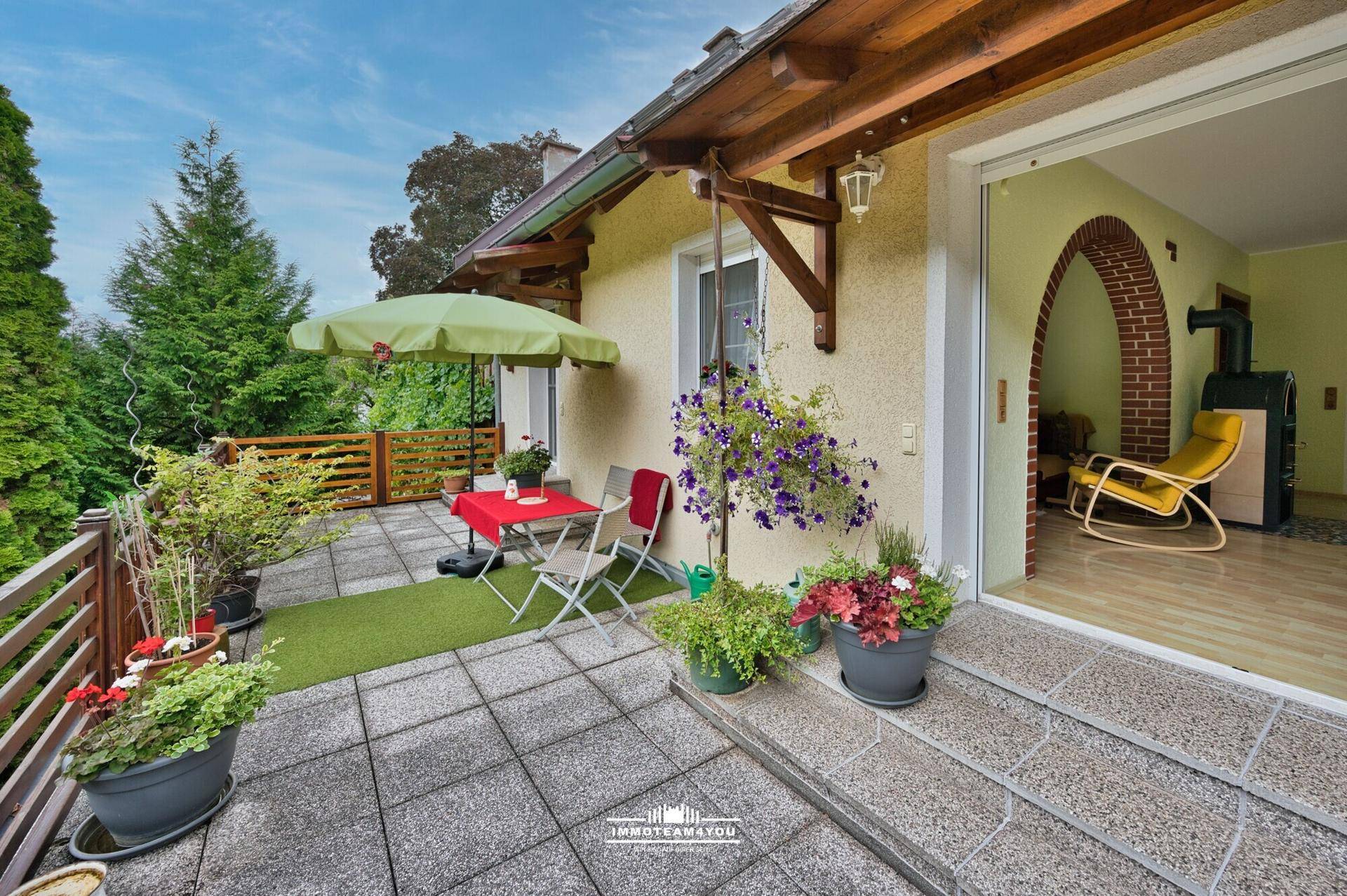 Gemütlicher Balkon mit Fliesenboden, Sitzgelegenheiten und Zugang zum Innenbereich.