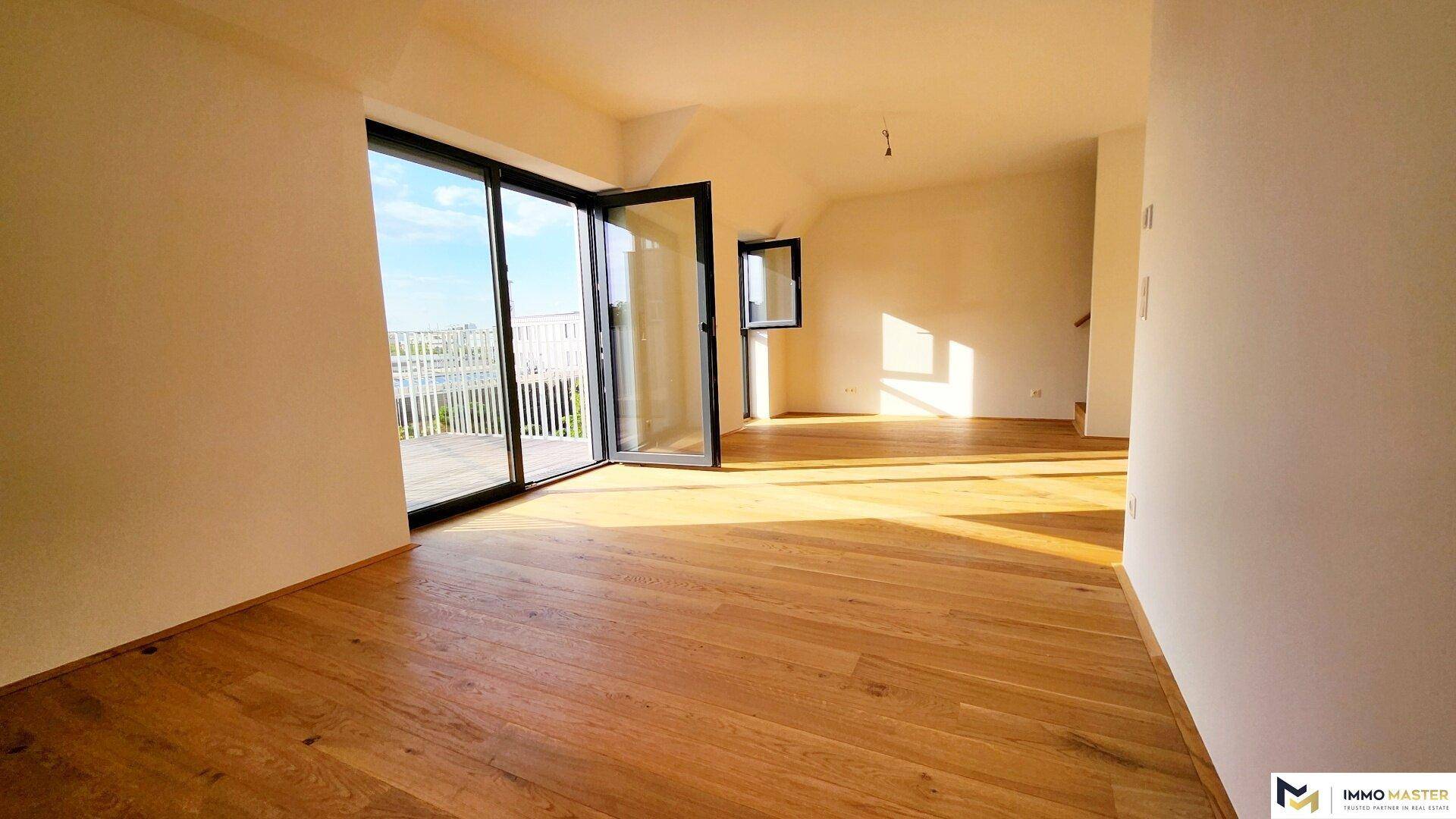 Lichtdurchfluteter Wohnbereich mit Holzboden und direktem Zugang zu einer sonnigen Terrasse.