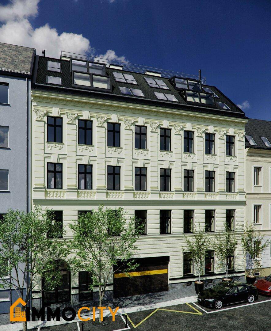 Historische Fassade eines Gebäudes mit modernen Dachfenstern und Parkplätzen davor.