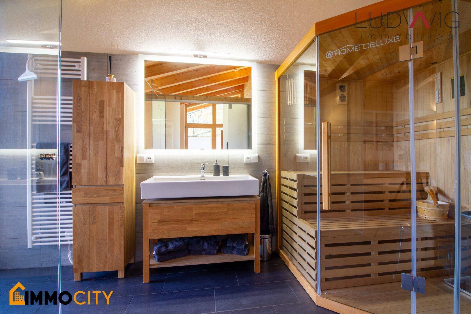 Modernes Badezimmer mit Sauna, Einzelwaschbecken und beheiztem Handtuchhalter.