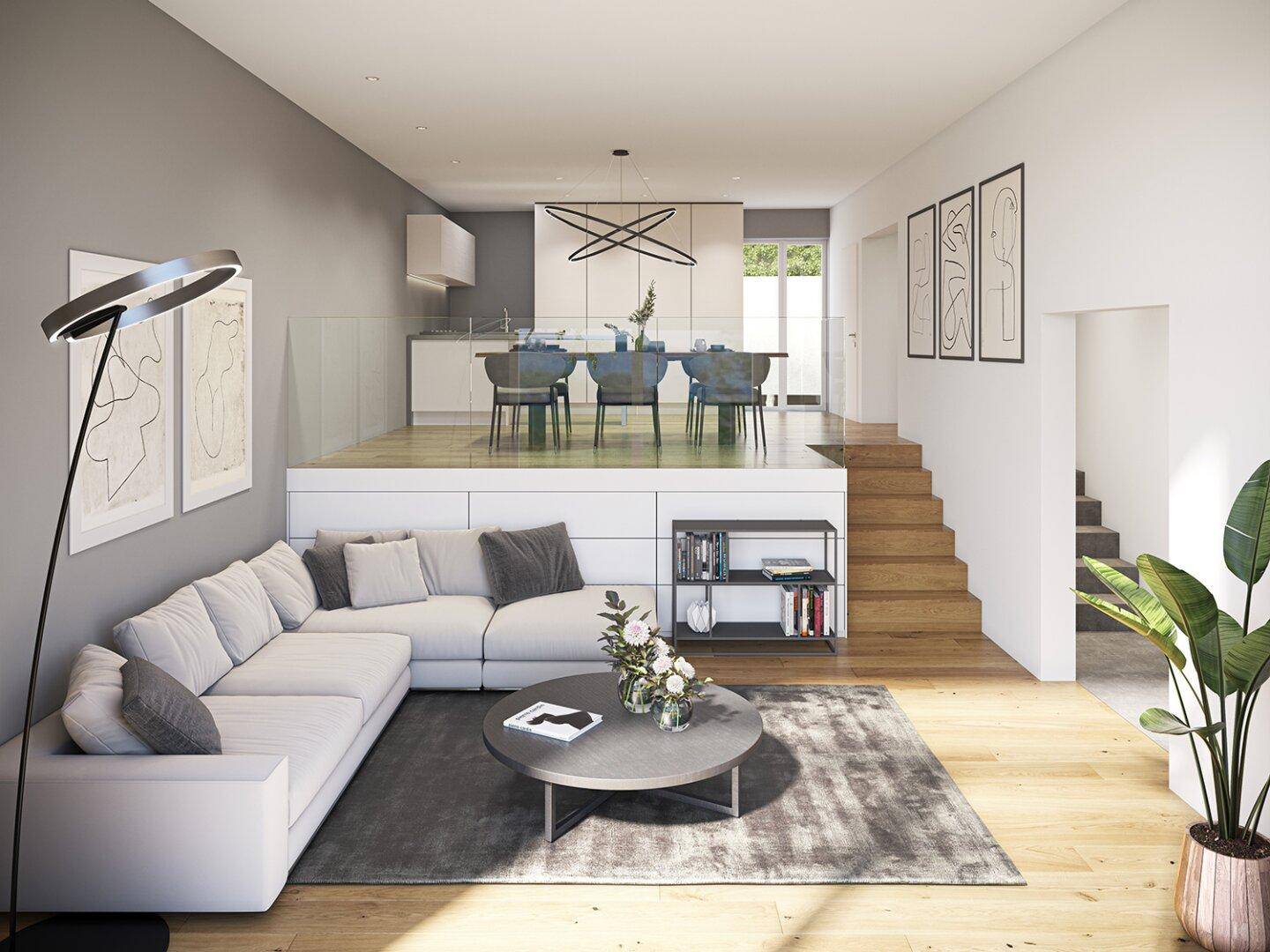 Modernes, offenes Wohn- und Esszimmer mit Holzboden und integrierter Küche auf zwei Ebenen.