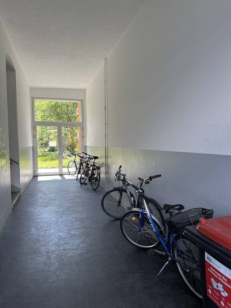 Gemeinschaftlicher Flur mit Fahrradabstellmöglichkeiten und großem Fenster zum Außenbereich.