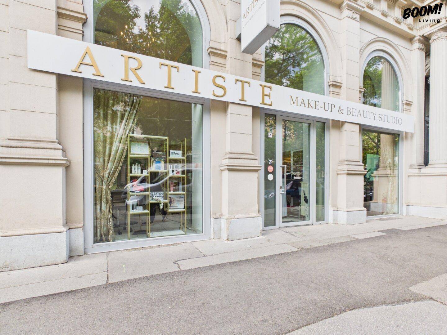 Außenansicht des "ARTISTE Make-up & Beauty Studio" mit großen Schaufenstern und klassischer Architektur.