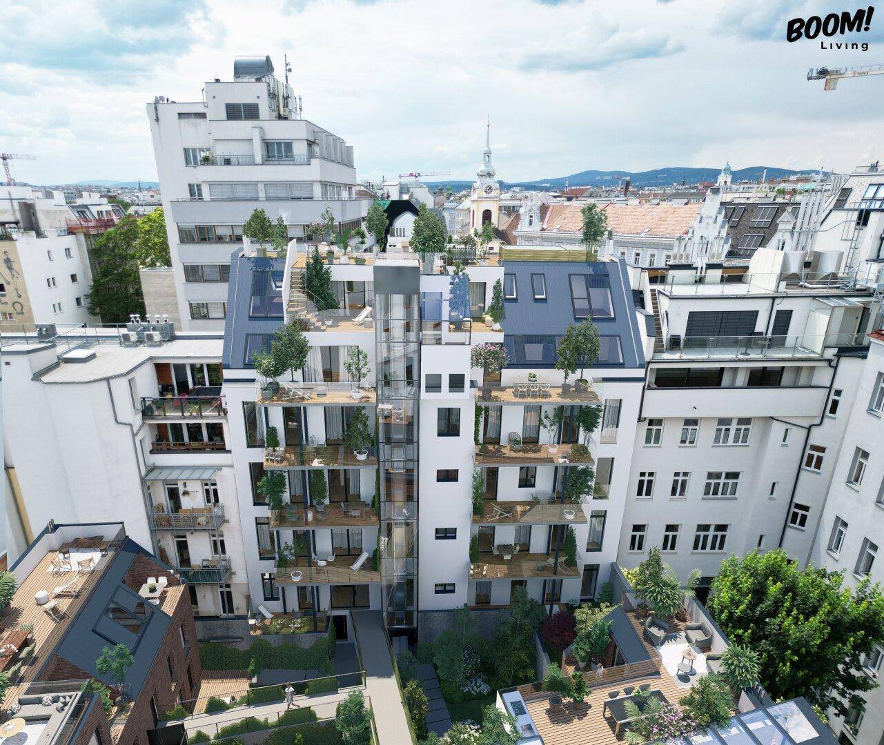 Luftaufnahme eines modernen Wohnkomplexes mit begrünten Terrassen und Innenhöfen in der Stadt.