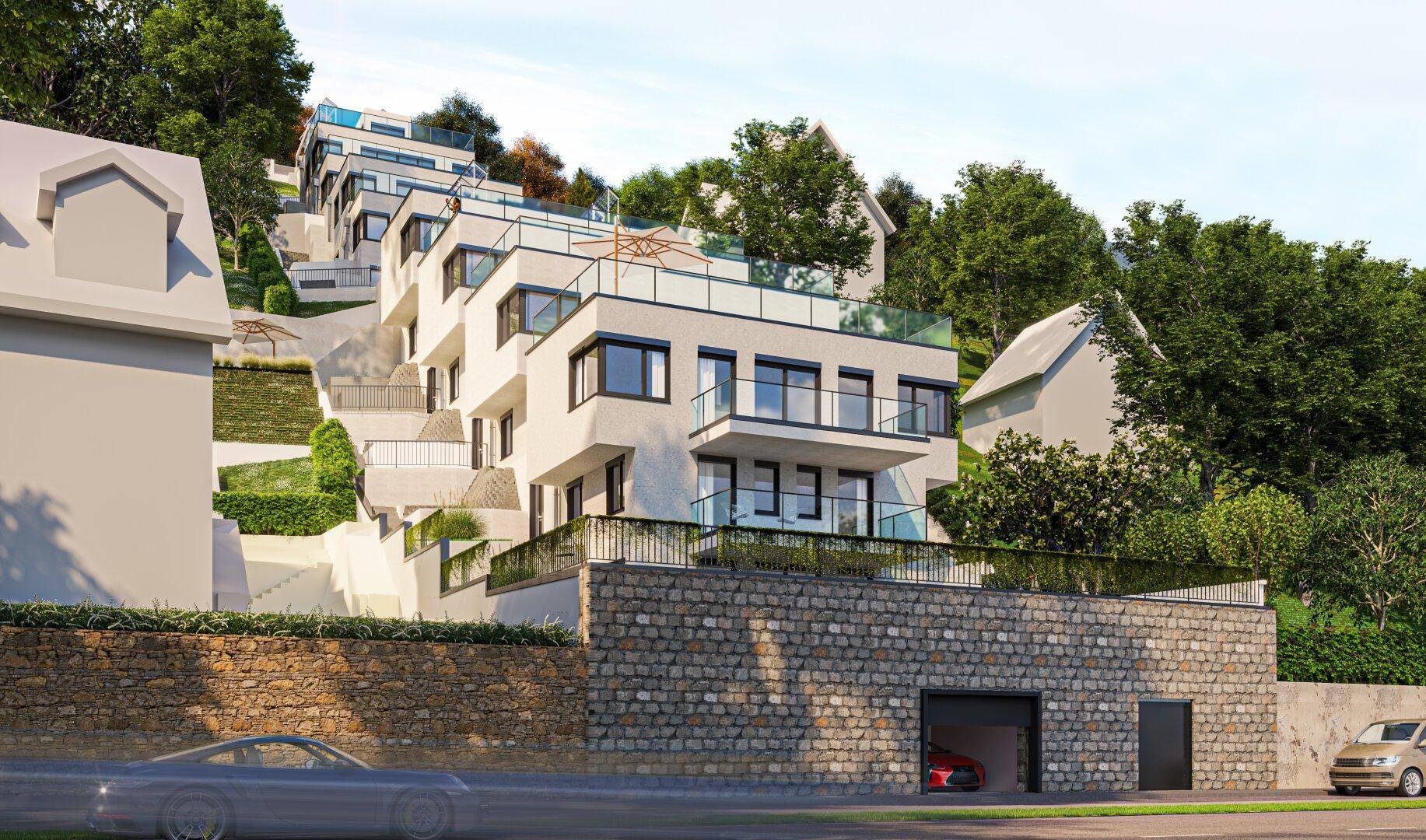 Moderne Wohnanlage in Hanglage mit Steinfassade und integrierter Tiefgarage.