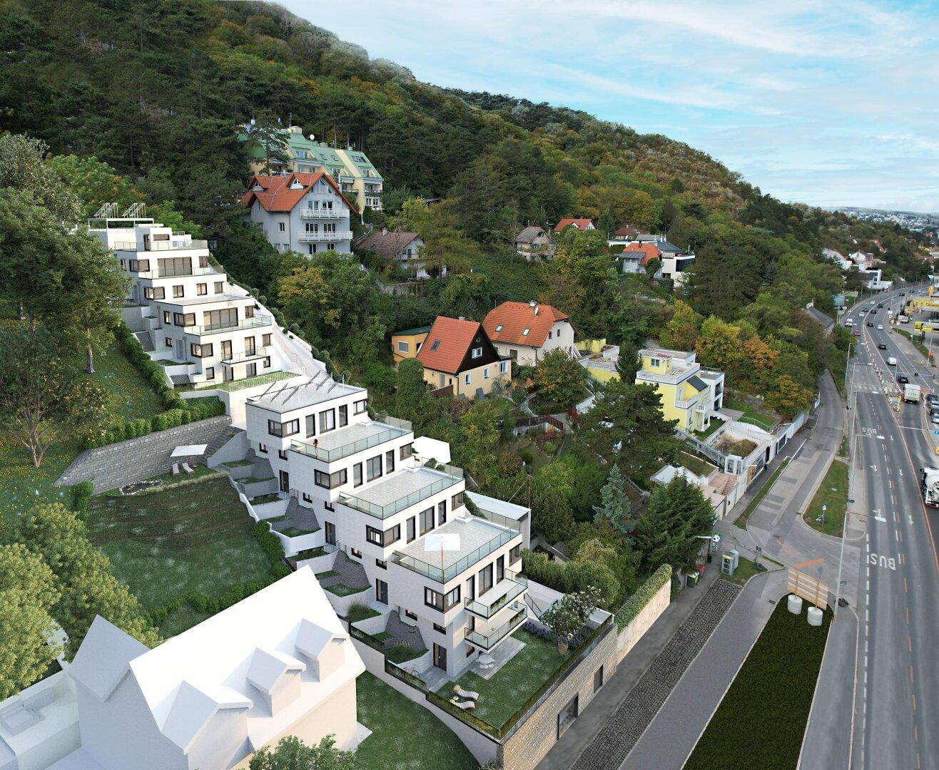 Luftaufnahme einer modernen Terrassenwohnanlage in Hanglage mit Blick auf die Umgebung.