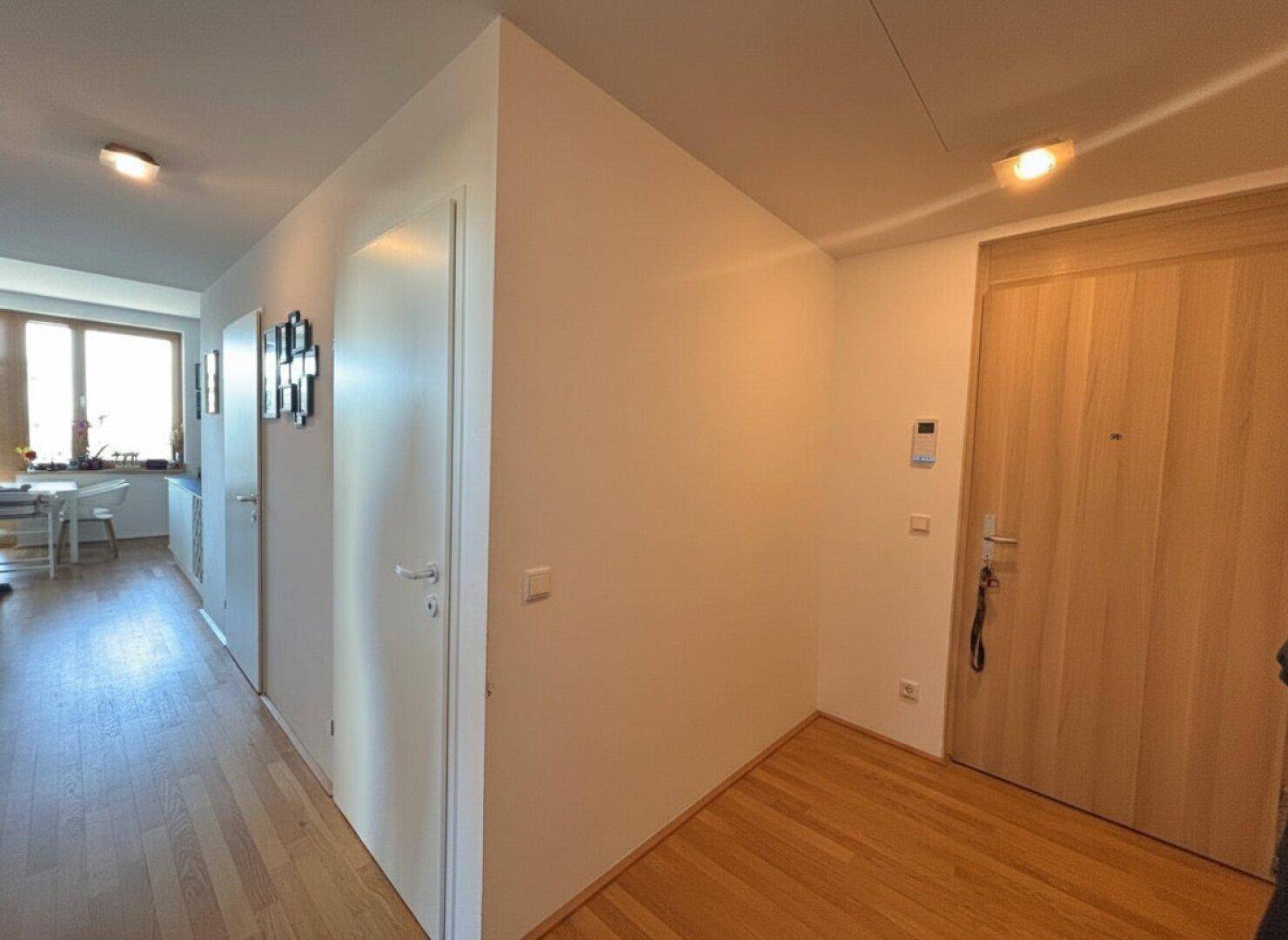 Geräumiger Flur mit Holzboden, der zu den verschiedenen Zimmern führt.