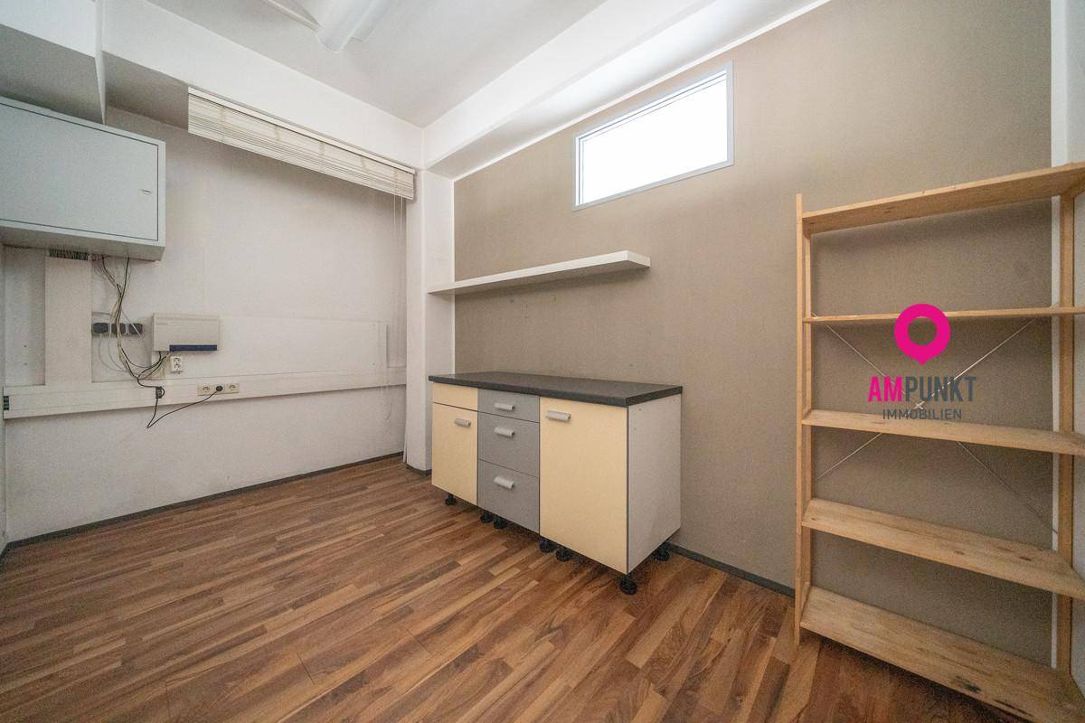 Kleiner Abstellraum oder Archiv mit Holzboden, einem Schrank und Regalen.
