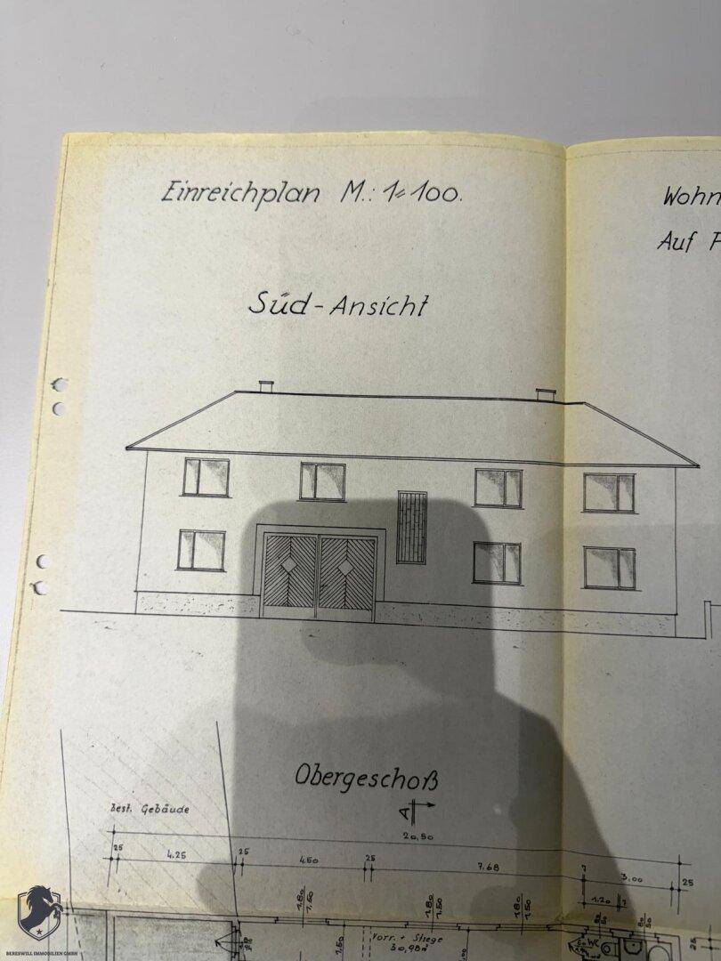 Südansicht des Wohnhauses mit doppeltürigem Eingangsbereich und mehreren Fenstern.