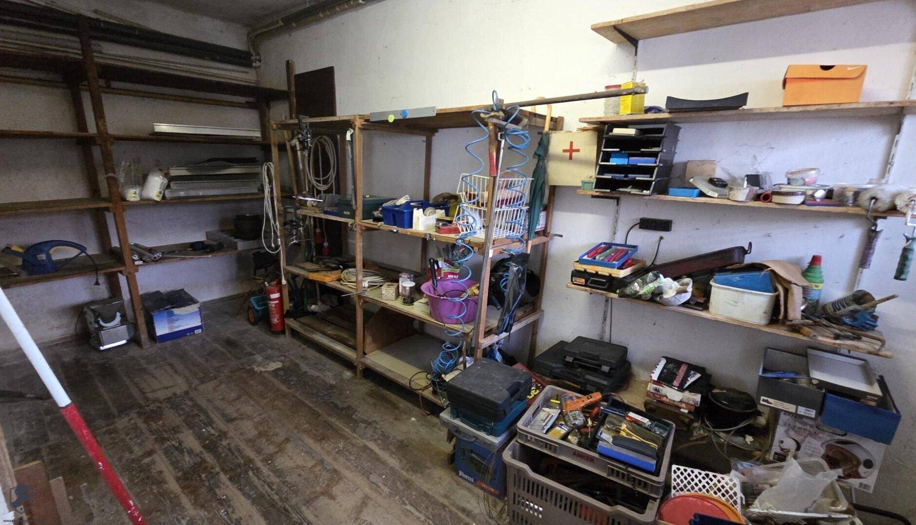 Praktischer Abstellraum oder Werkstatt mit vielen Regalen für Lagerung.