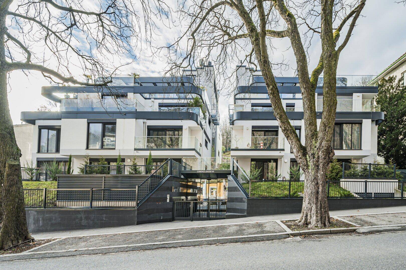 Moderne Wohnanlage mit mehreren Einheiten, Glasbalkonen und ansprechender Architektur.
