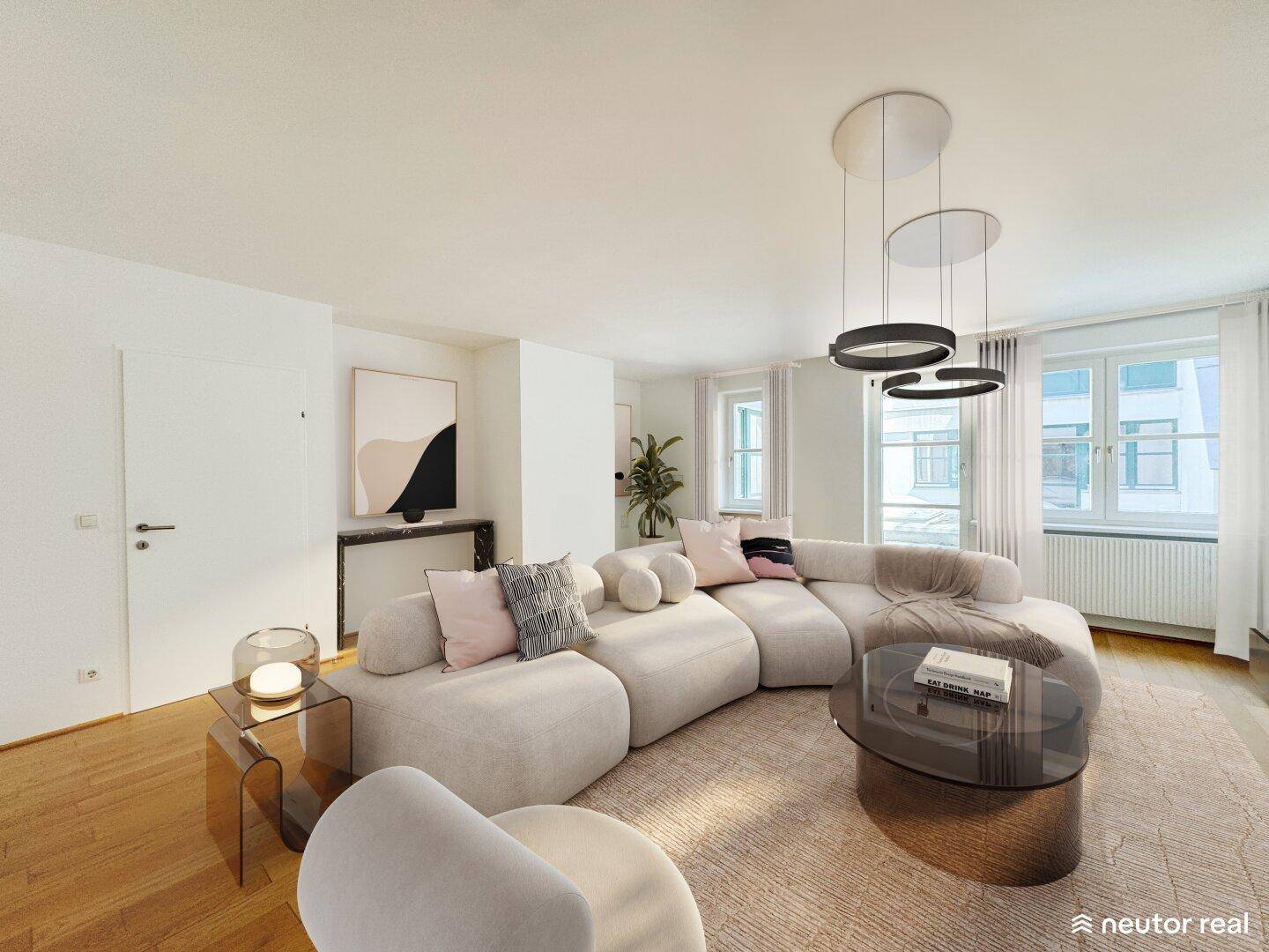 Helles, modernes Wohnzimmer mit großem, geschwungenem Sofa und stilvoller Einrichtung.