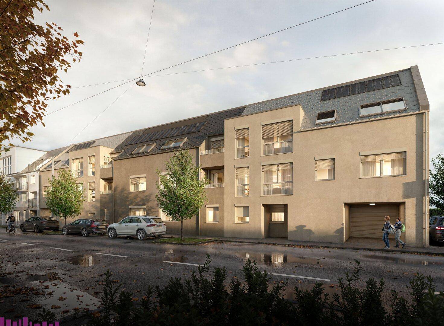 Moderne Wohngebäude mit Garagenzugang und Photovoltaikanlage an einer städtischen Straße.