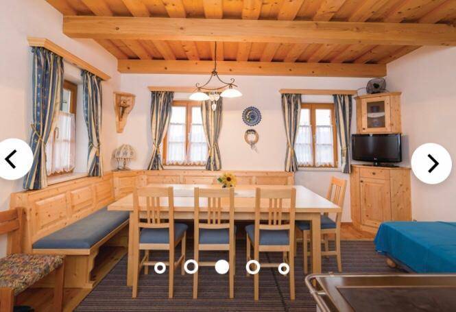 Gemütliches Schlafzimmer mit zwei Einzelbetten, Holzboden und sichtbaren Holzbalken an der Decke.