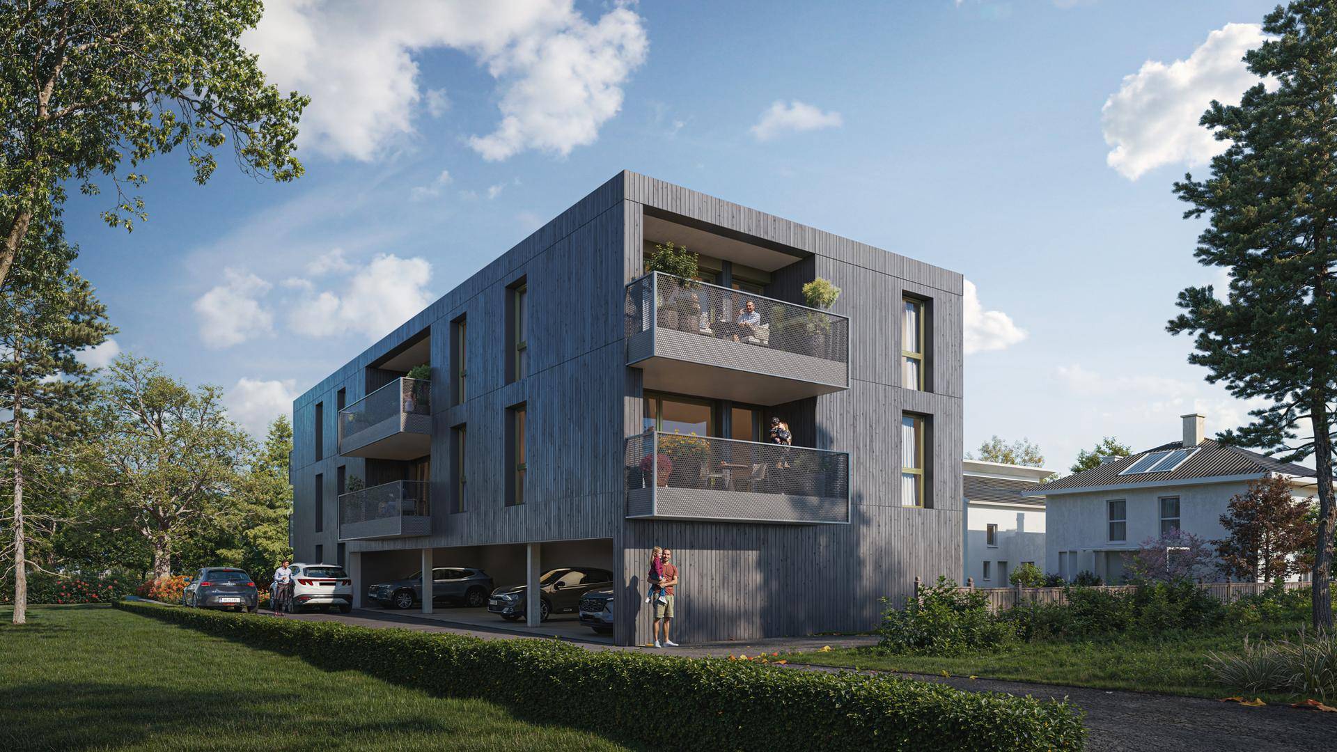 Moderne Fassade des Wohngebäudes mit Balkonen und überdachten Parkplätzen im Erdgeschoss.