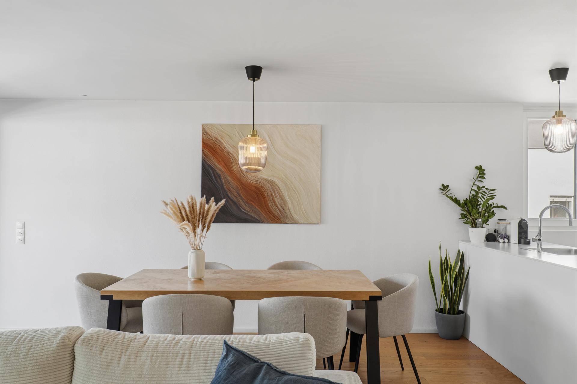 Heller Essbereich mit modernem Holztisch und stilvoller Pendelleuchte.