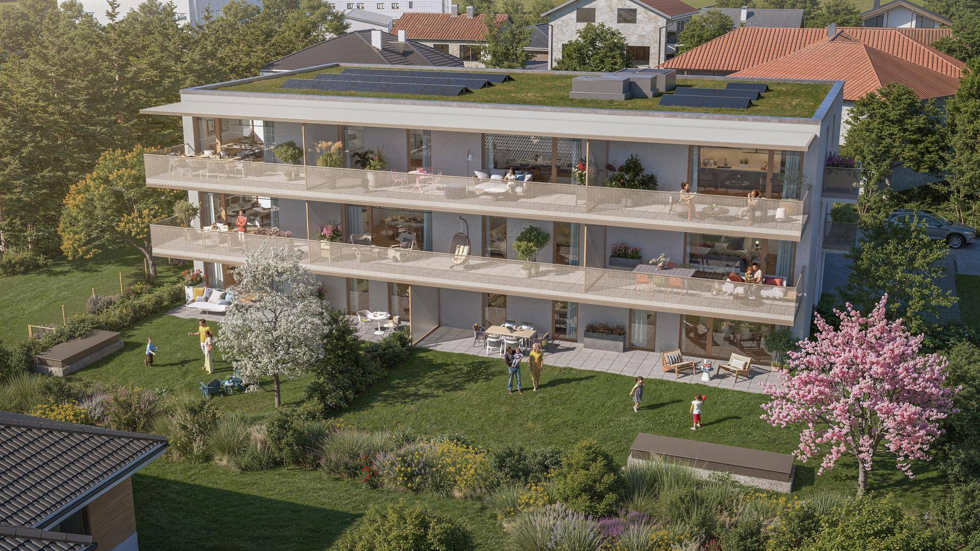 Panoramablick auf die moderne Wohnanlage mit großzügigen Balkonen, Terrassen und einem weitläufigen Gartenbereich.