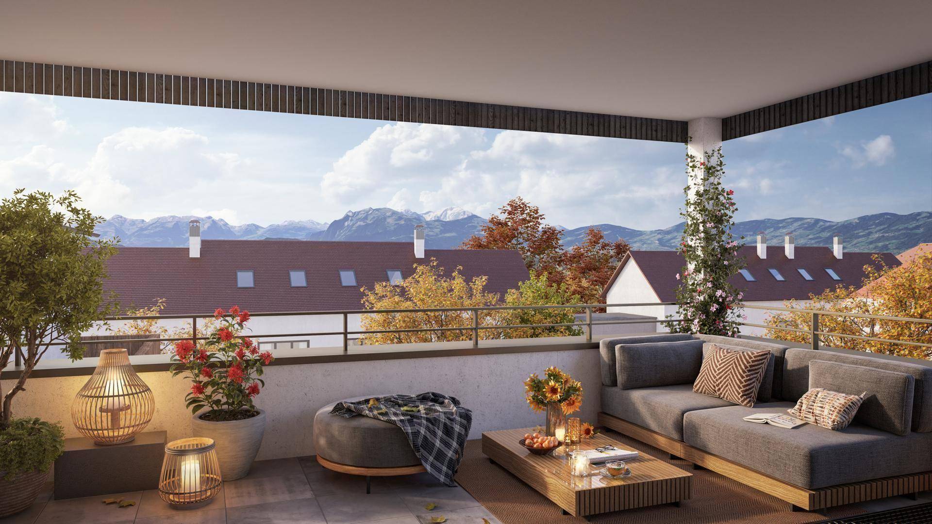 Geräumiger Balkon mit stilvollen Outdoor-Möbeln und einem weiten Panoramablick auf die Alpen.