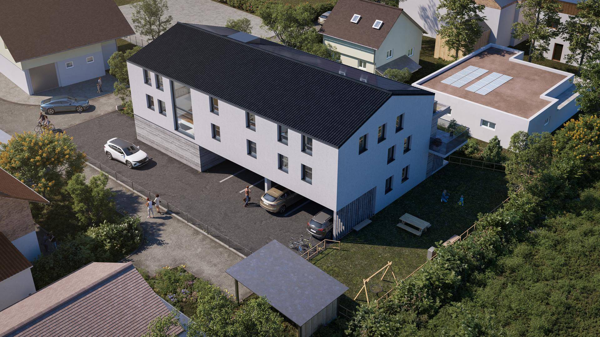 Vogelperspektive des Neubaus mit Photovoltaikanlage, Carport und umliegenden Wohnhäusern.